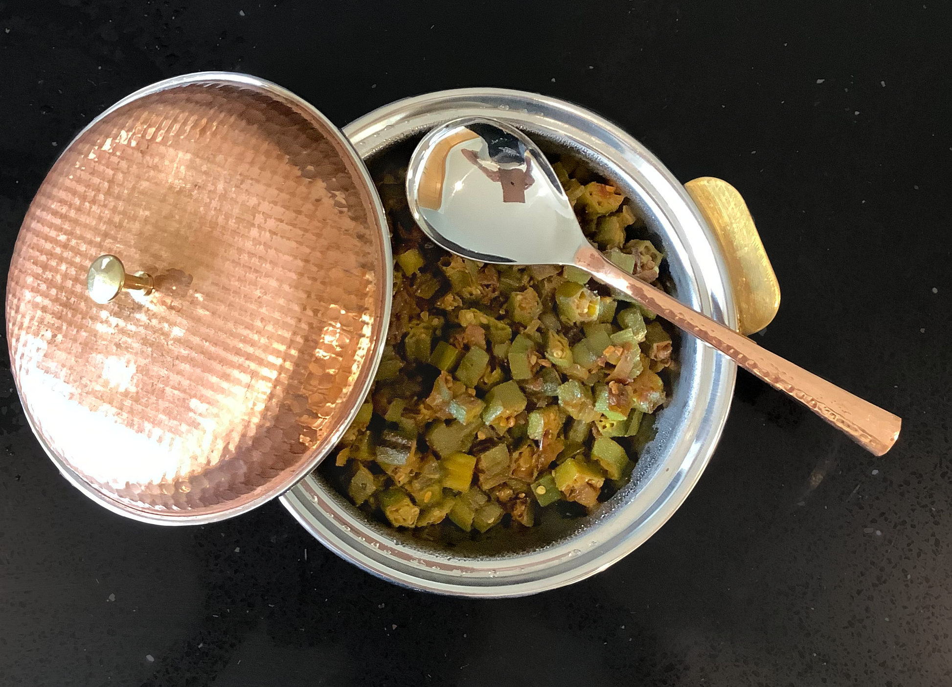 Photo of Bhindi Bhaji in a metallic copper coloured bowl.