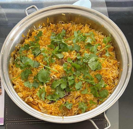 photo of hyderbadi dum byriani in a metallic bowl