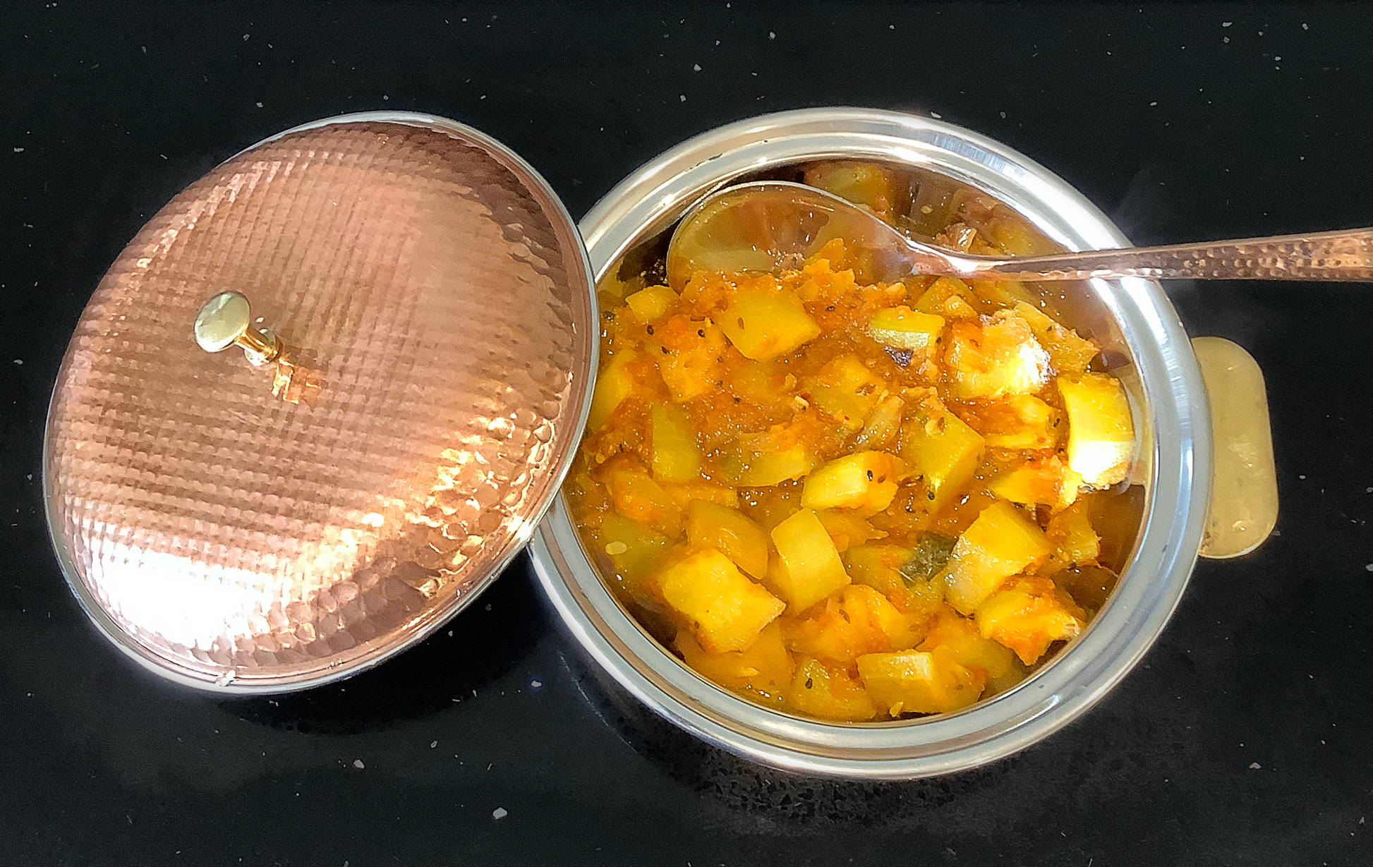 Photo of Aloo Methi in a metallic copper coloured bowl.