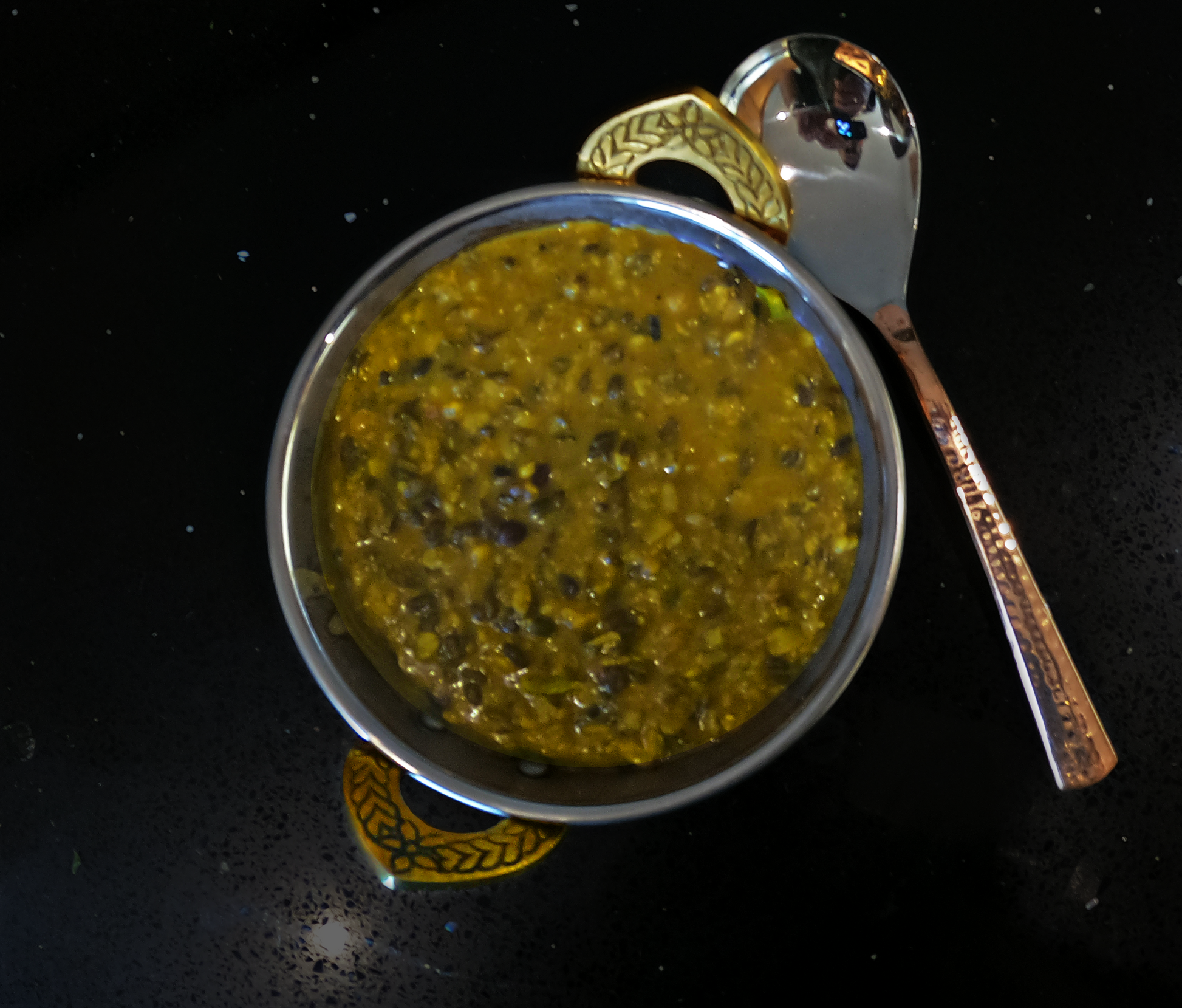 Daal Makhani in a copper coloured metallic bowl.