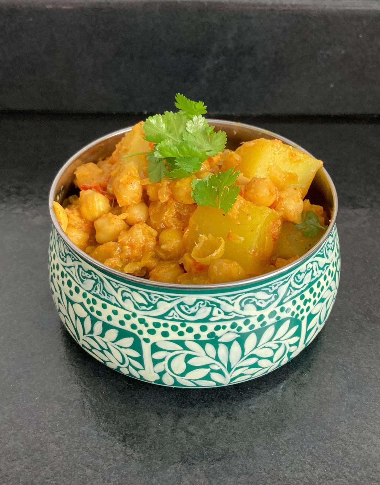 Photo of Aloo Cholay in a blue bowl. 