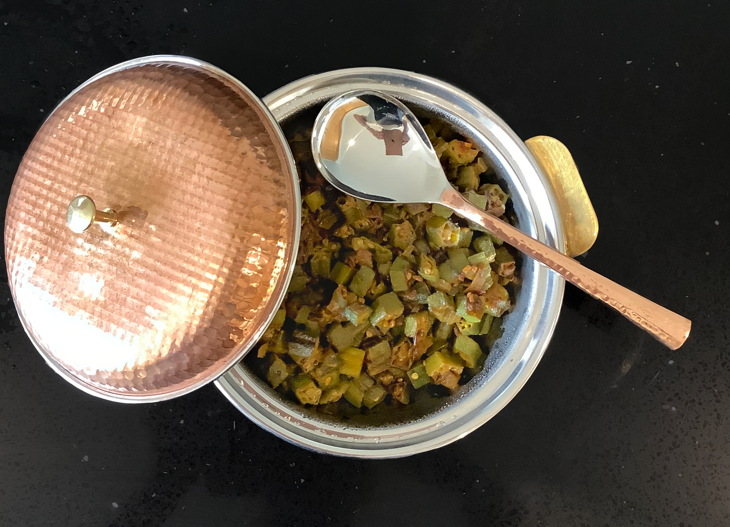 Photo of Bhindi Bhaji in a metallic copper coloured bowl.