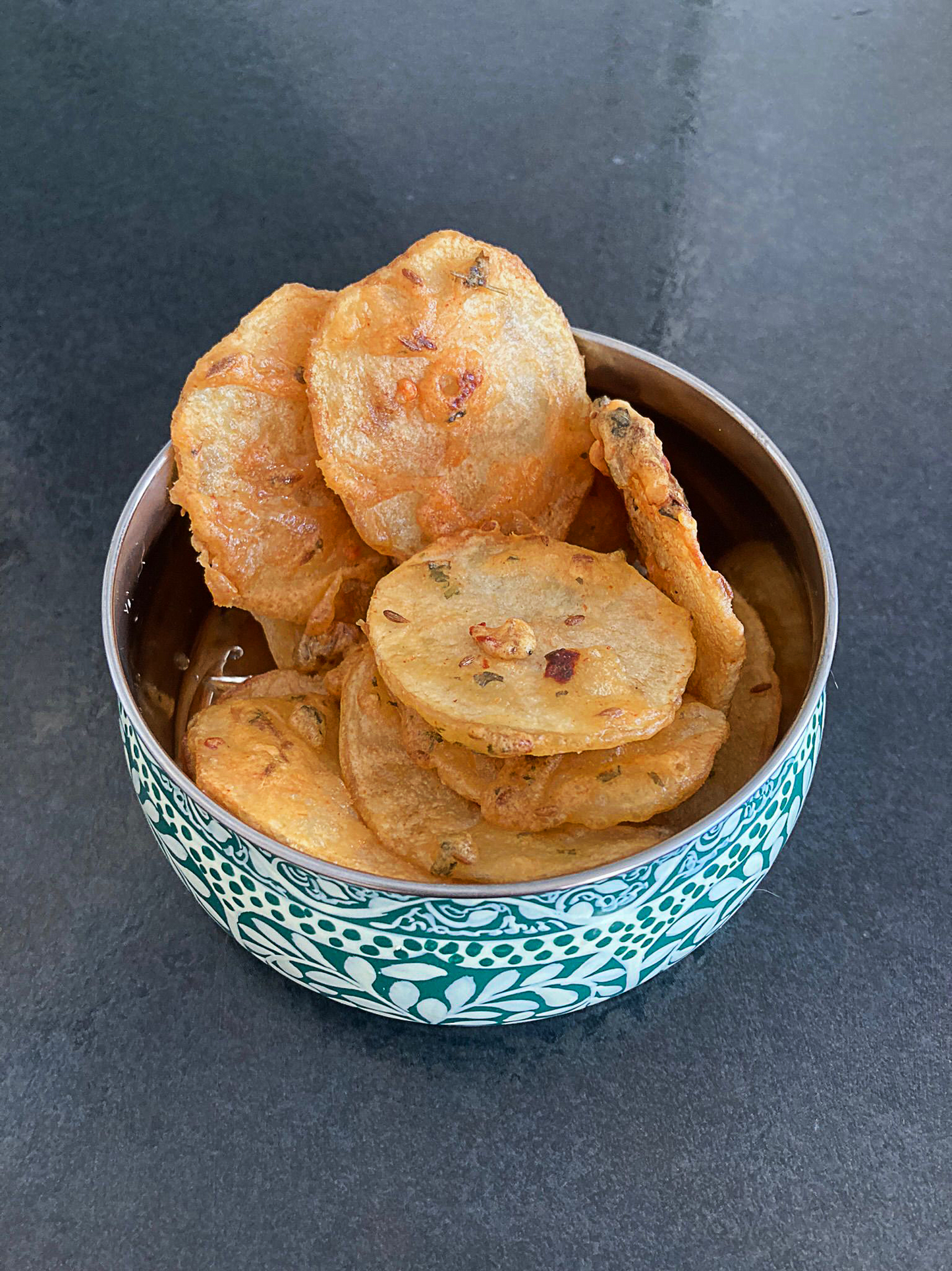 Photo of crispy potato bhajia in a blue bowl