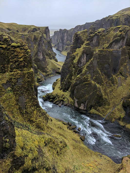 a landscape image of Iceland showing a river through some mountainous terrain.