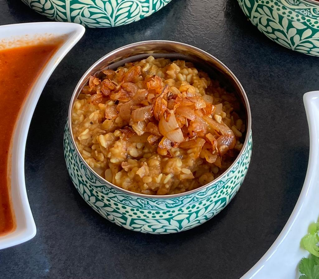 Photo of mixed tarka daal in a blue bowl.