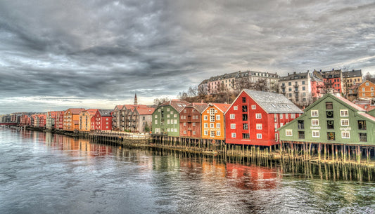A scenic photo of stilted houses on a body of water in Norway