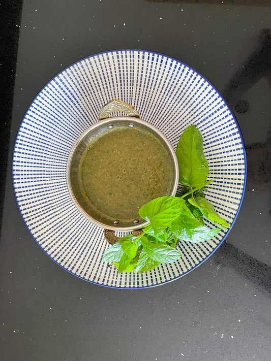 Spicy mint chutney in a blue bowl
