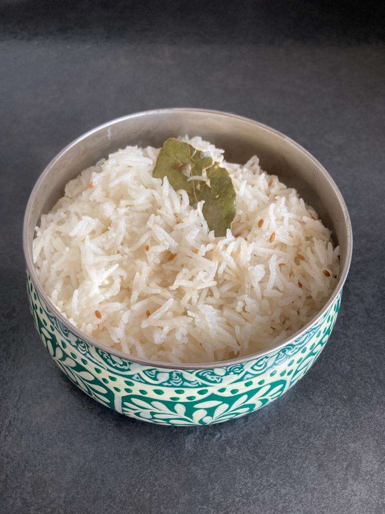 Tarka zeera Rice in a blue bowl. 