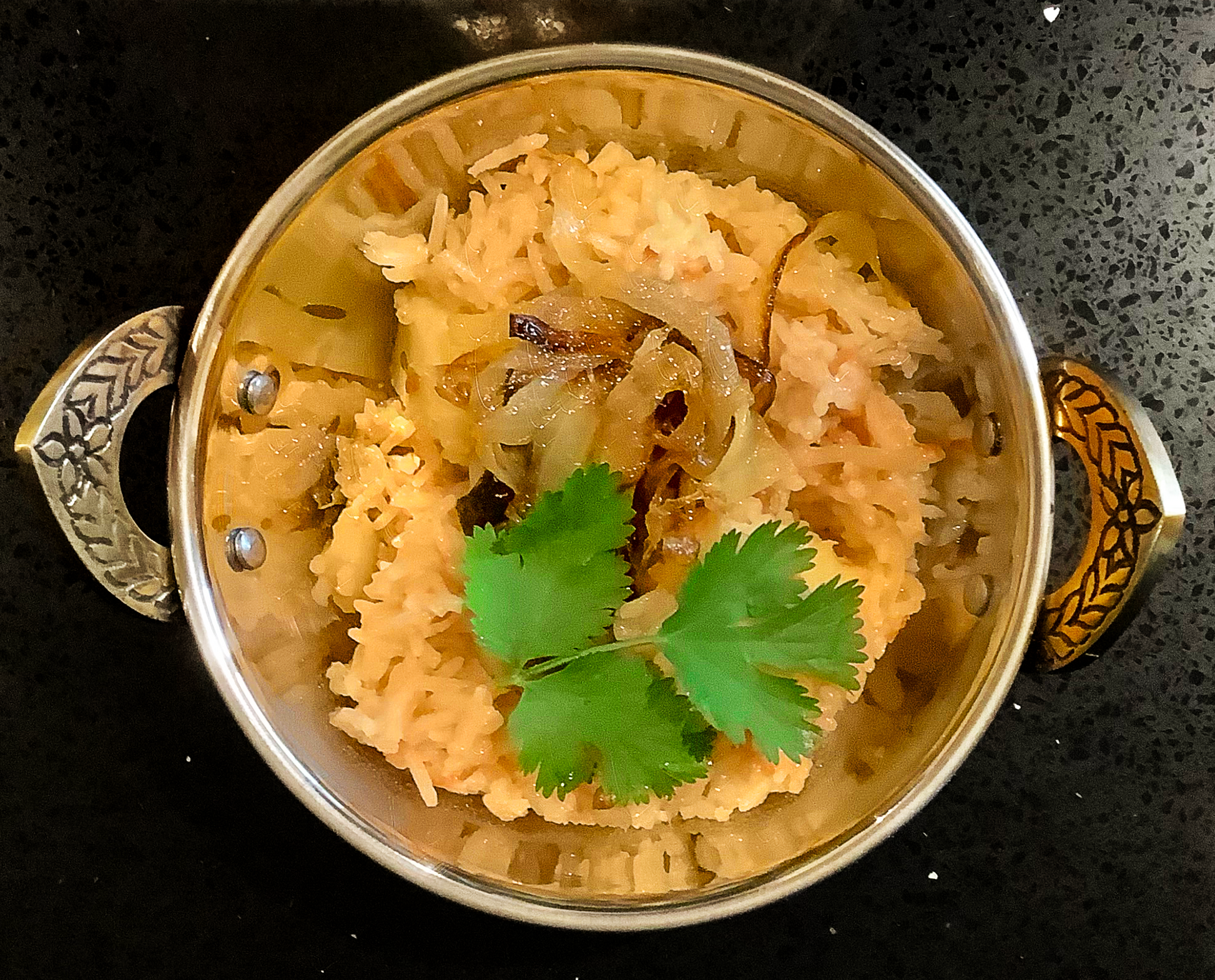 Tarka Zeera Rice in a copper coloured metallic bowl. 