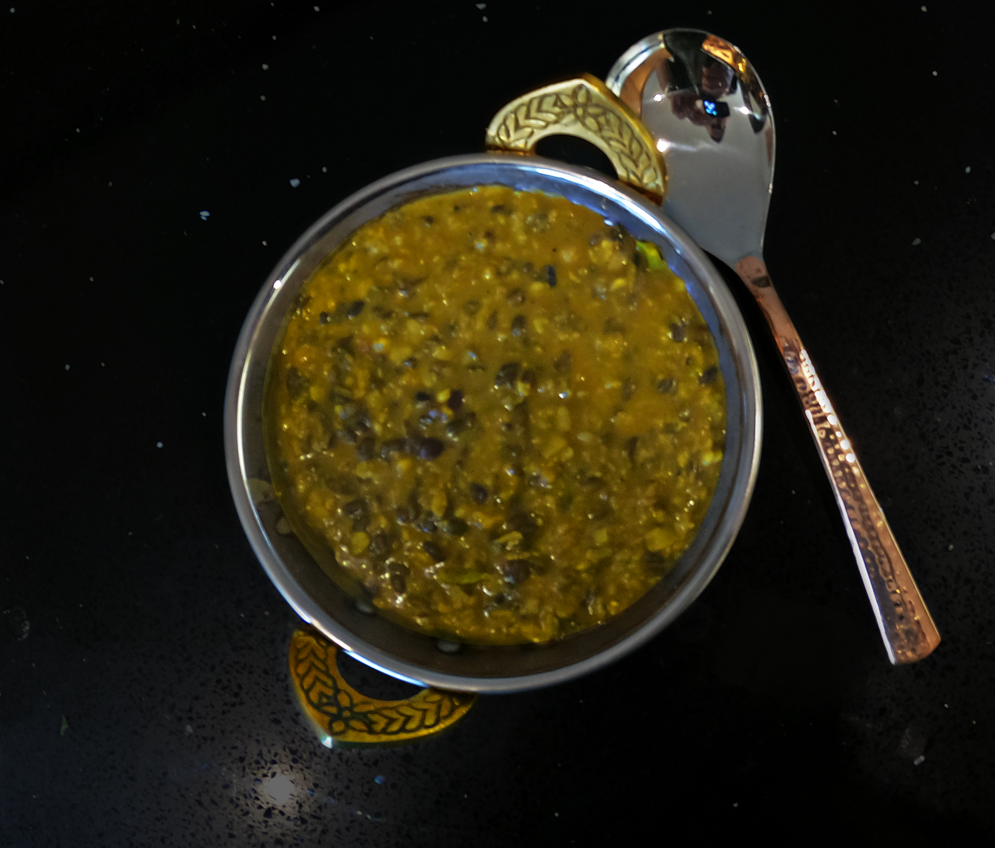 Daal Makhani in a copper coloured metallic bowl. 