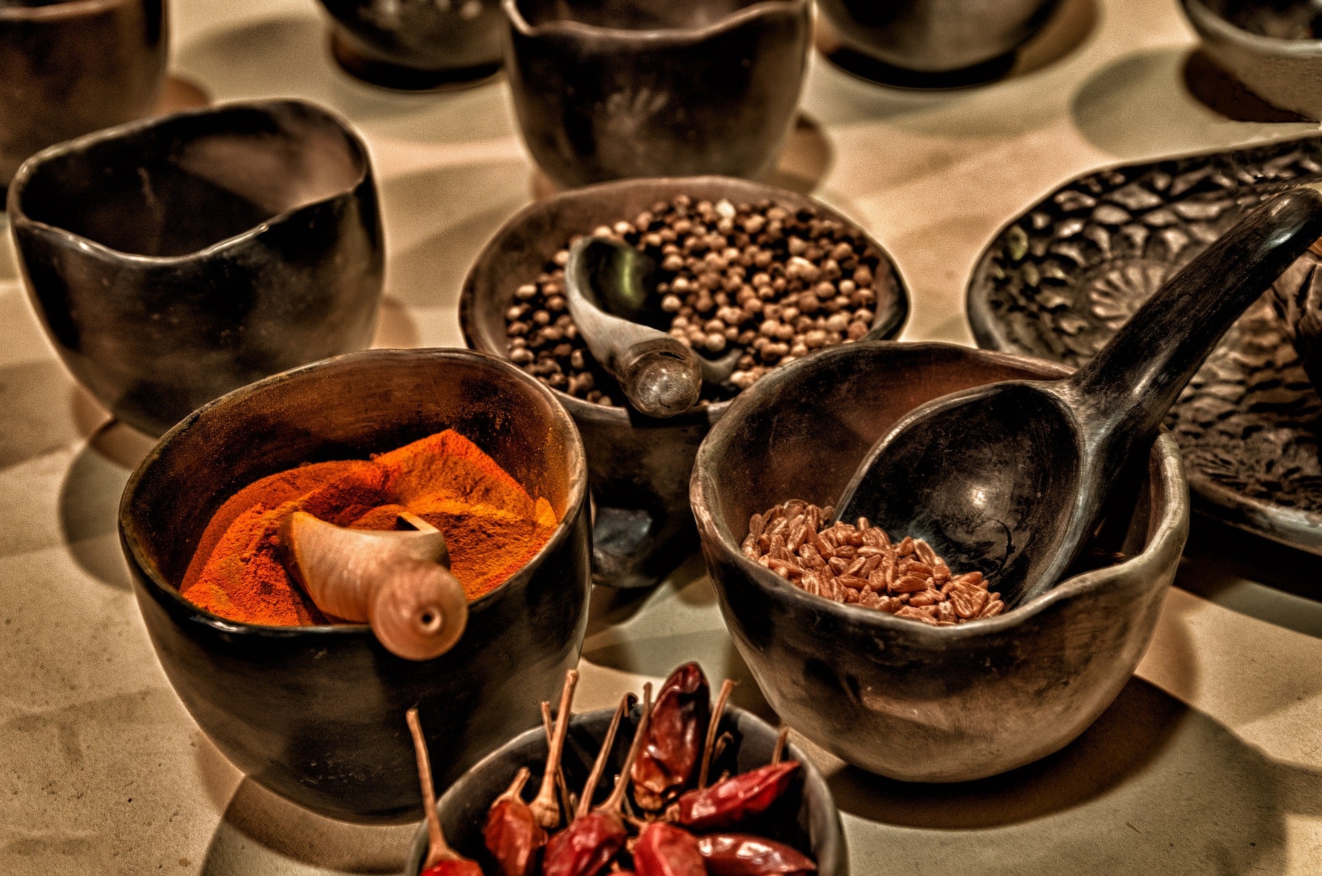 Bowls of spices, both whole and ground. 